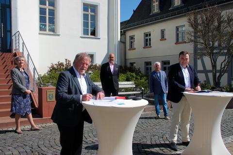Die Vertreter von CDU und SPD bei der Unterzeichnung des Koalitionsvertrags unter freiem Himmel in Usingen. Foto: Hammerschmied 
