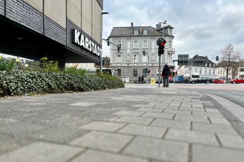 Das alte Pflaster vor Karstadt in Limburg auf dem Gehweg an der Diezer Straße soll mit finanzieller Unterstützung des Landes Hessen ausgetauscht werden; im Hintergrund ist die Schiede-Kreuzung zu sehen.
