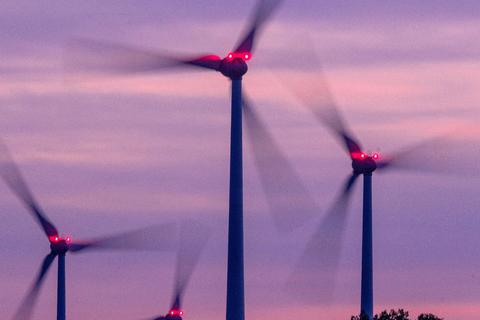 Windräder drehen sich nach Sonnenuntergang in einem mecklenburgischen Windpark. Foto: Jens Büttner/dpa