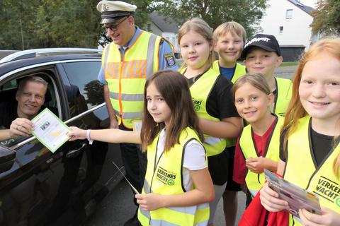 Grüne und gelbe Karten verteilen die Kinder vor der Philipp-Schubert-Schule in Hermannstein an die Autofahrer. 