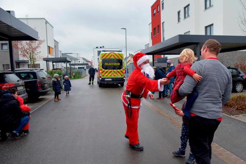 Feuerwehrleute verteilen Schoko-Nikoläuse, zur Freude der Kinder. Foto: hbz/Kristina Schäfer 