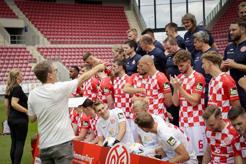 Aufstellen fürs Mannschaftsfoto: 05-Mediendirektor Tobias Sparwasser (vorne links) bringt Spieler und Staff in Position. 