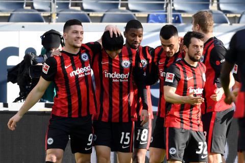 Frankfurts Spieler jubeln mit dem Torschützen zum 1:0 Daichi Kamada. Foto: dpa